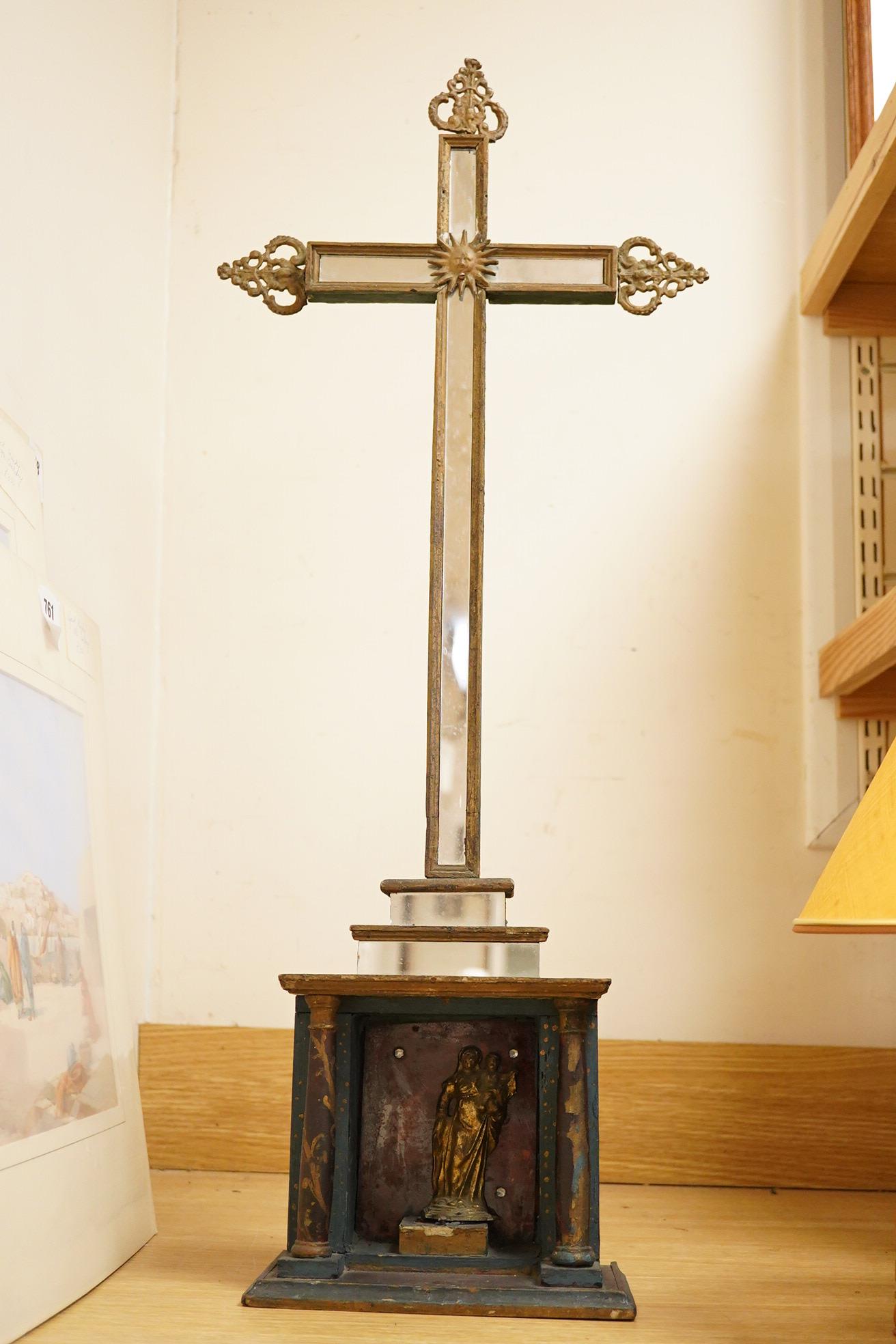 An early 19th century painted pine cross with mirrored front and a cast gilt metal statue of Mary and child, 78cm high